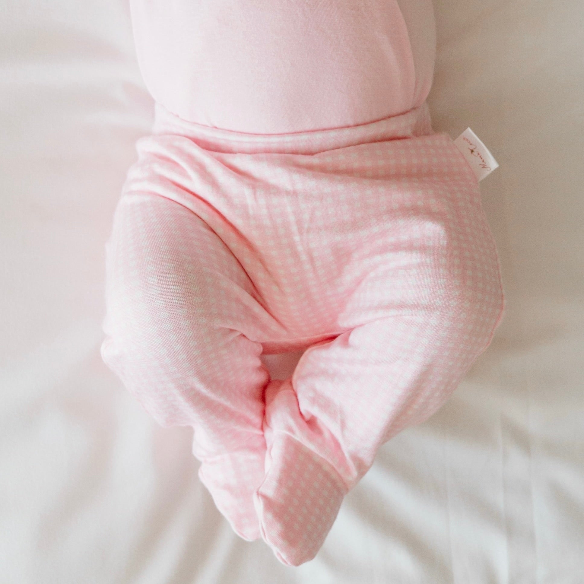 Baby Pink Gingham baby footie pants crafted from silky modal fabric for maximum comfort.