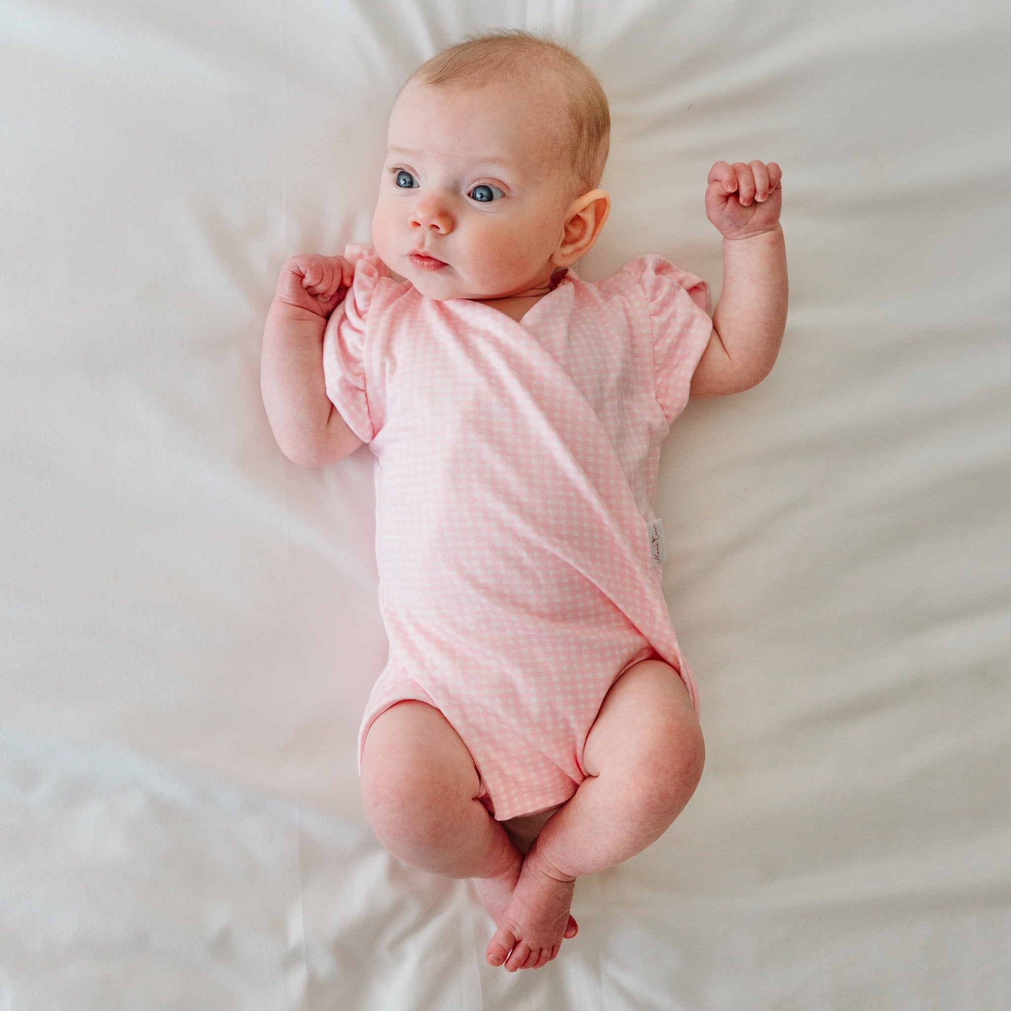 Flutter sleeve baby onesie in Baby Pink Gingham design.