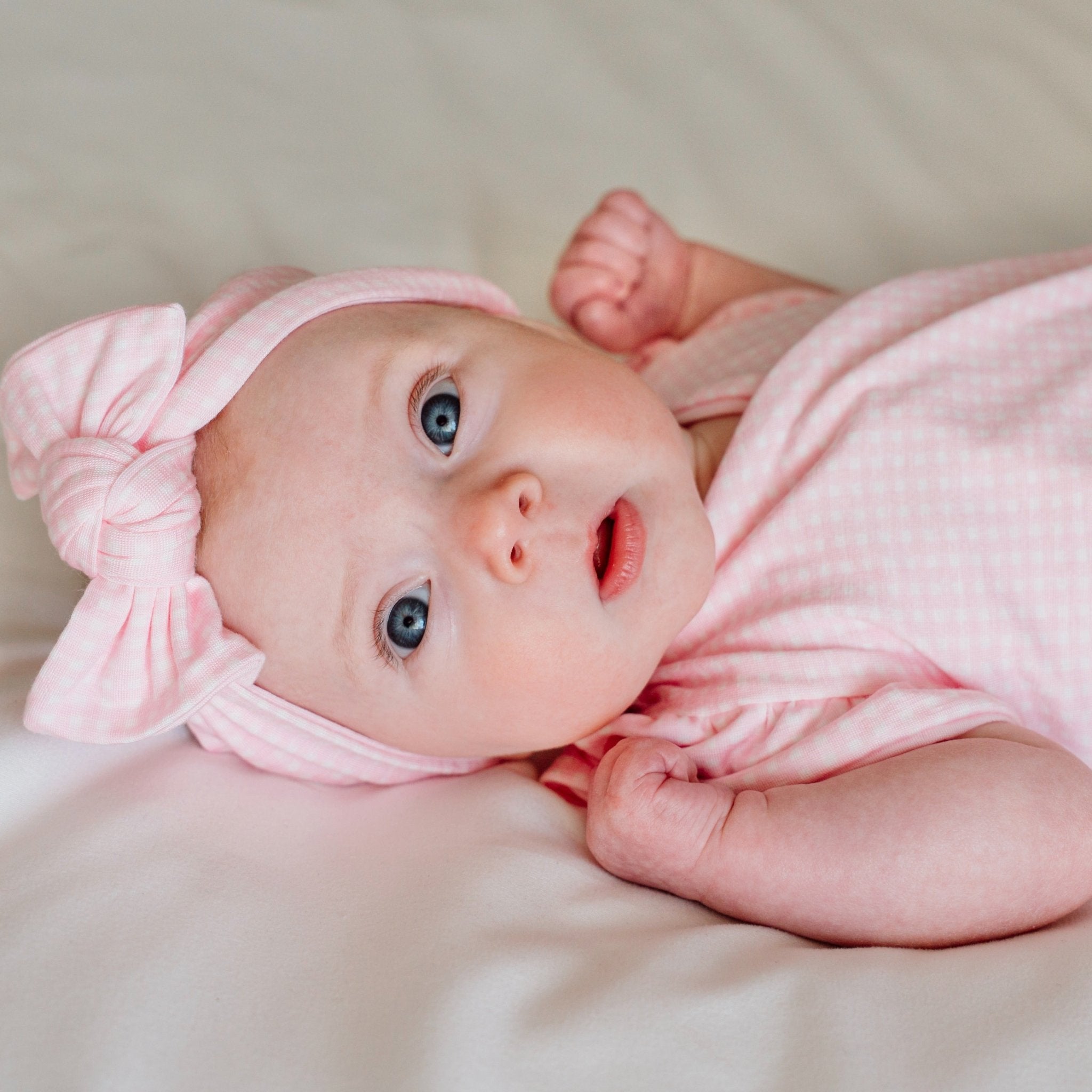 Charming headwrap with decorative bow in Baby Pink Gingham styles.