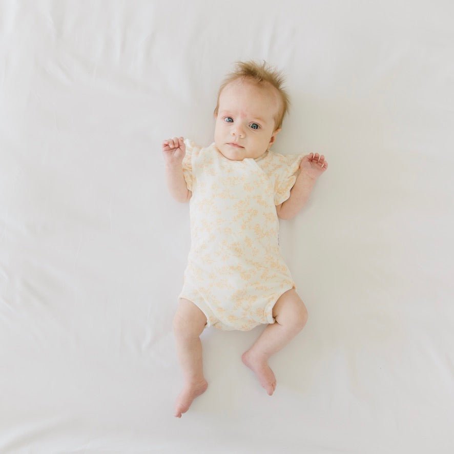 Bitty Blooms design flutter sleeve winged bodysuit for babies in silky modal fabric.
