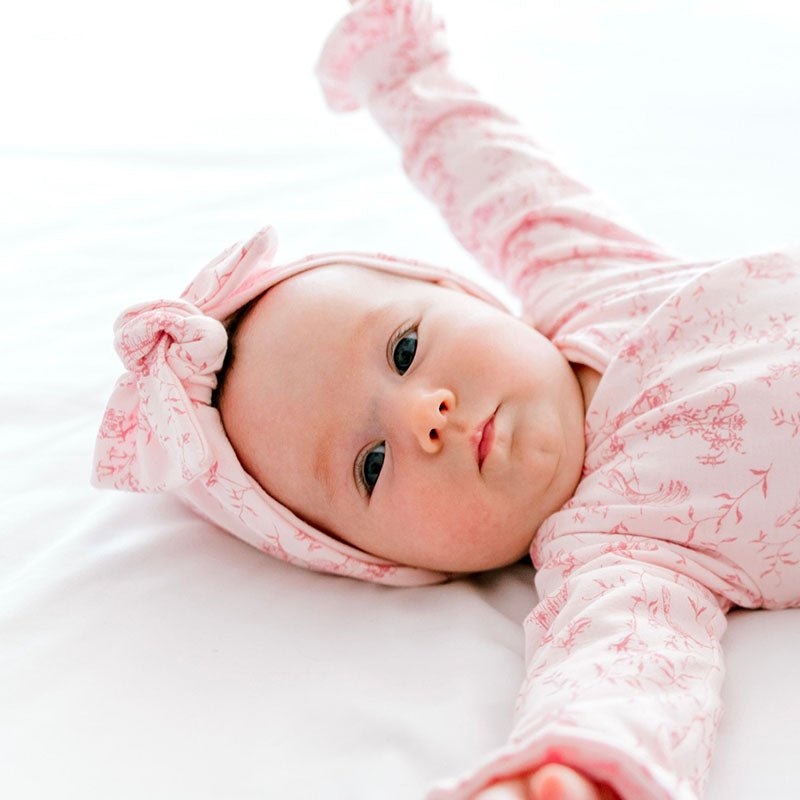 Bamboo cotton baby ruched bow beanie in whimsical garden design.
