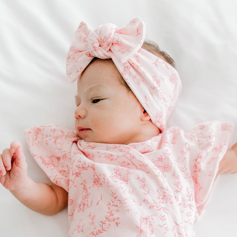 Cute baby bow headwrap made with bamboo and organic cotton fabric featuring a whimsical garden pattern.
