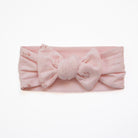 Adorable baby headwrap with bow, made from a bamboo and organic cotton blend in dainty dots.
