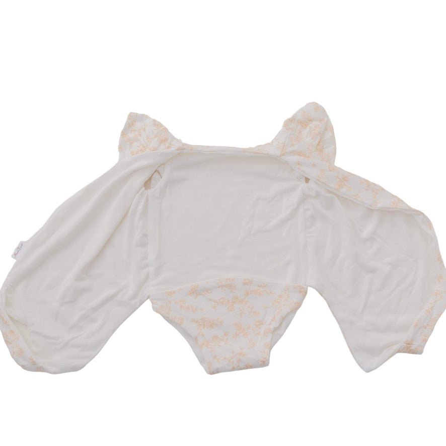 Reversible Bitty Blooms design flutter sleeve winged bodysuit in silky modal fabric.