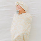 Bitty Blooms cocoon swaddle baby blanket in Silky Modal fabric styles with delicate floral accents.