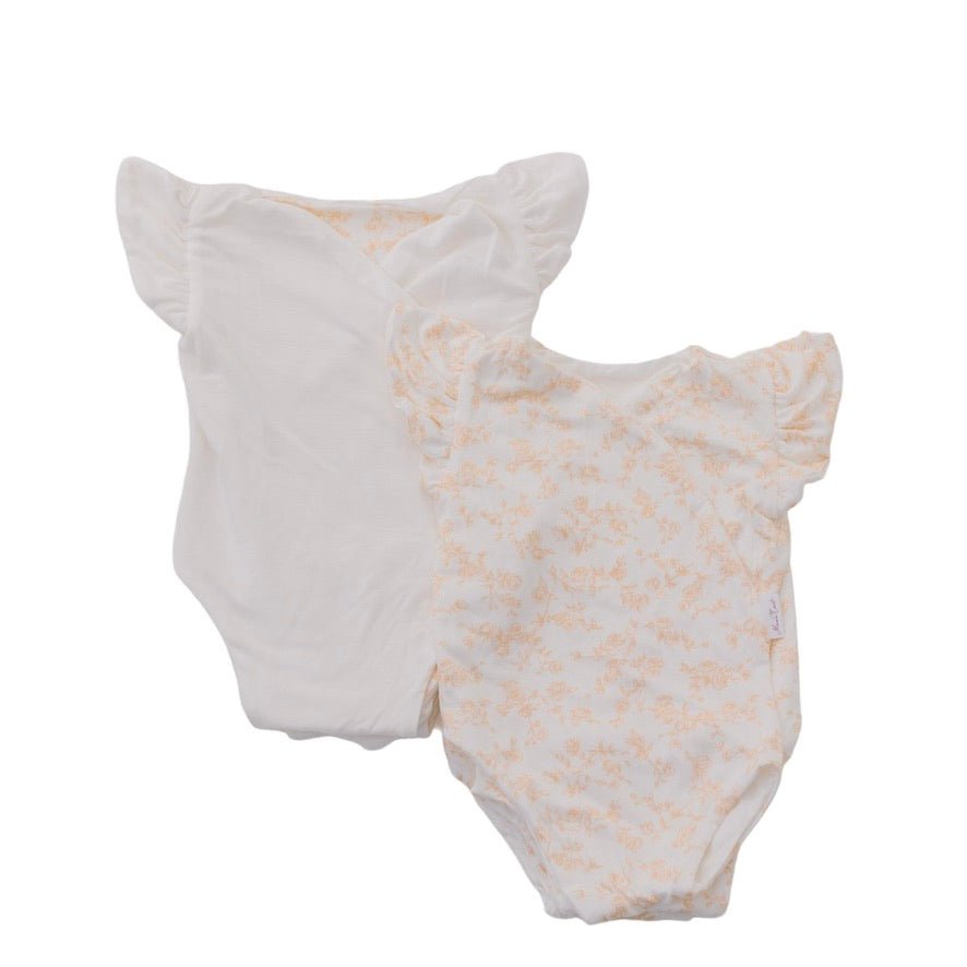 Reversible flutter sleeve baby onesie in bitty blooms design.