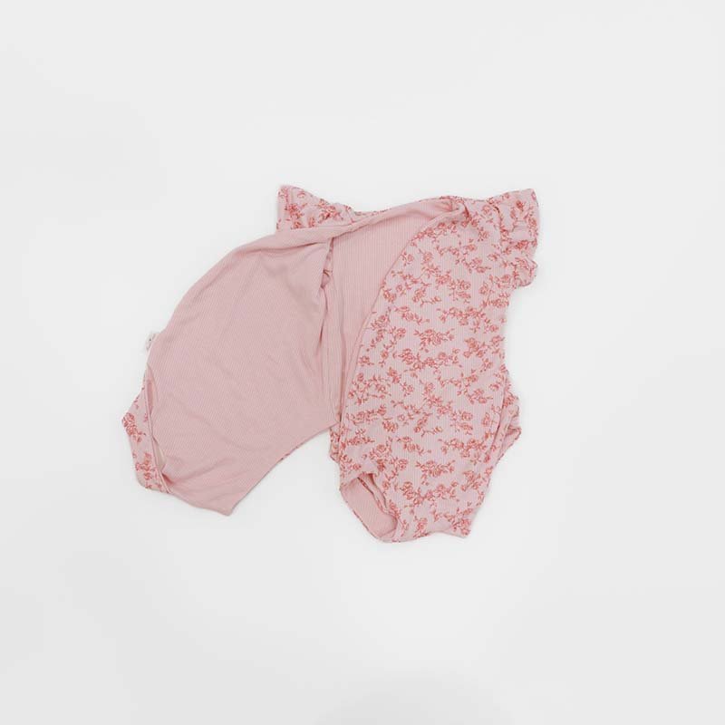 Reversible Bitty Pink Blooms design flutter sleeve winged bodysuit in silky modal fabric.