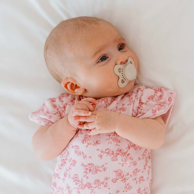 Bitty Pink Blooms design flutter sleeve baby onesie in silky modal fabric.