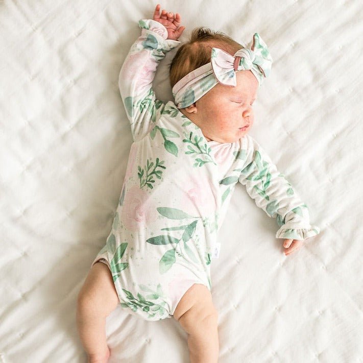 Soft Blushing Eucalyptus design brushed fabric baby bodysuit with winged sleeves and elegant ruffle cuffs.