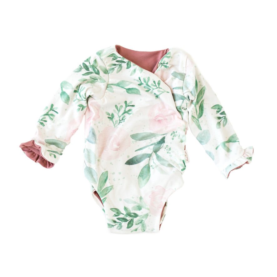 Reversible blushing eucalyptus long sleeve ruffle cuff baby onesie.
