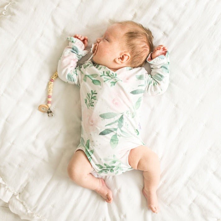 Long sleeve winged baby bodysuit featuring ruffle cuffs in soft Blushing Eucalyptus design brushed fabric.