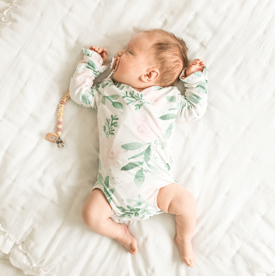 Blushing eucalyptus design ruffle cuff long sleeve onesie.