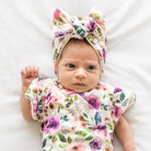 Charming baby headwrap with decorative bow in Ivory Wildflowers styles.