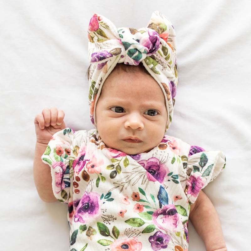 Charming baby headwrap with decorative bow in Ivory Wildflowers styles.