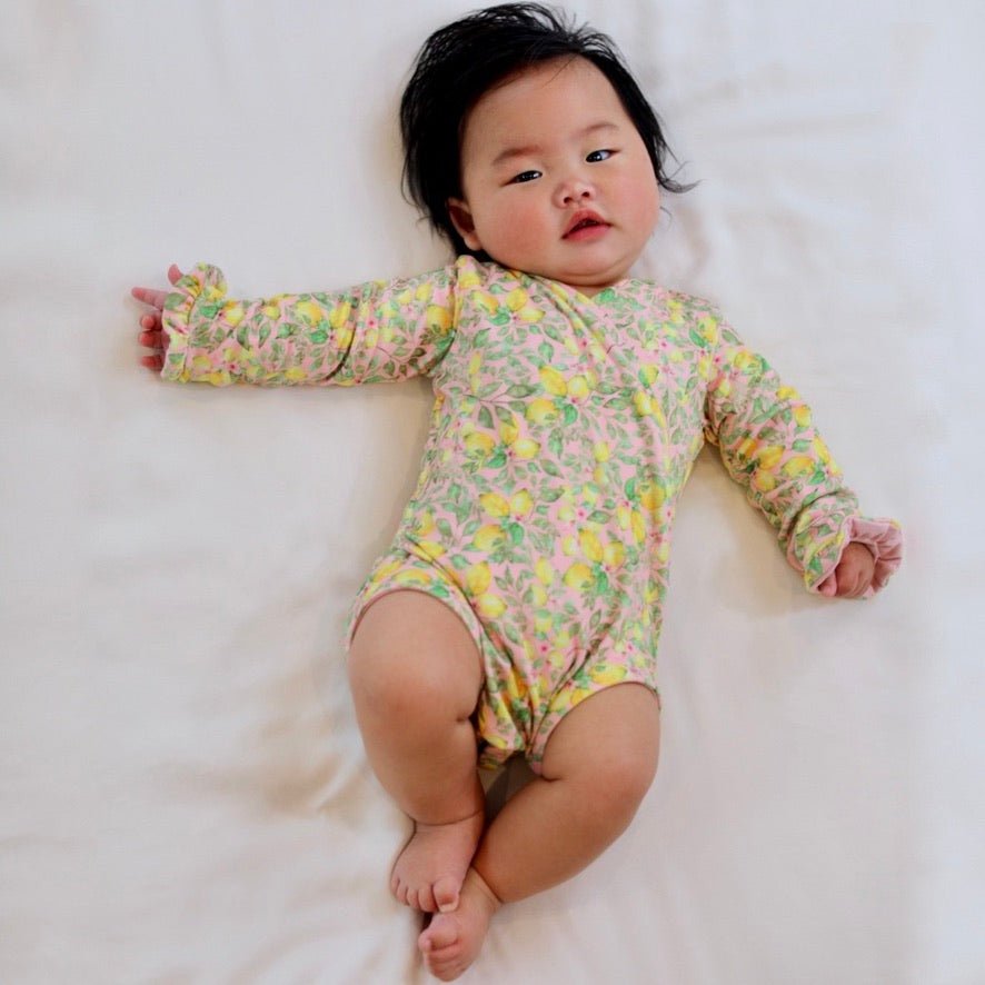 Classic brushed fabric baby bodysuit in Pink Lemonade design with long sleeves, winged, and ruffle cuffs.