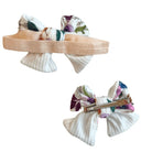 Floral baby bow headband and clip set in the Ivory Wildflowers pattern.