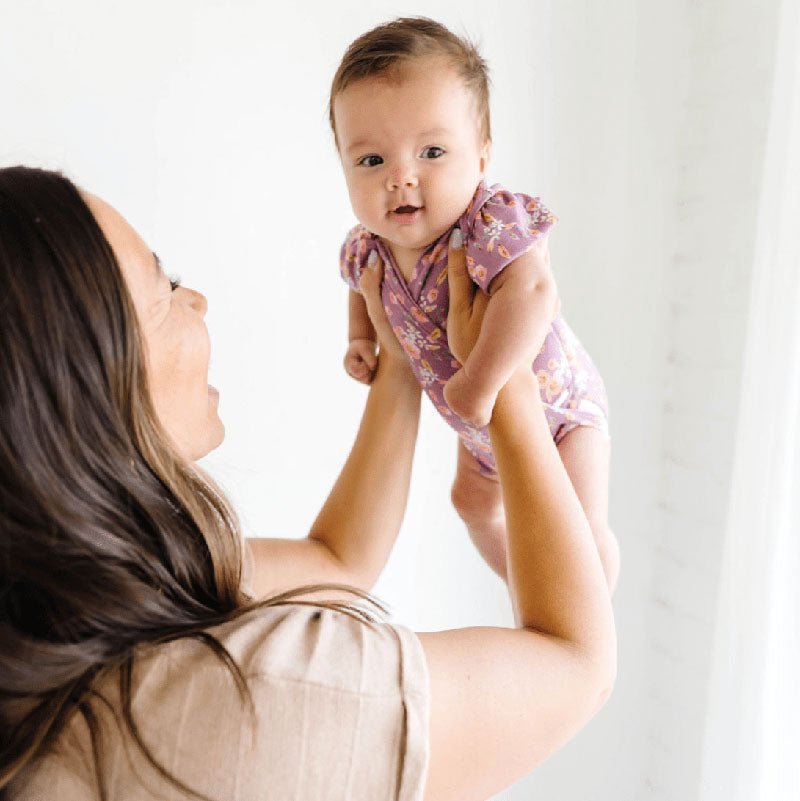 Floral Peachy Lilac short-sleeve bodysuit for baby in Classic Brushed fabric styles.