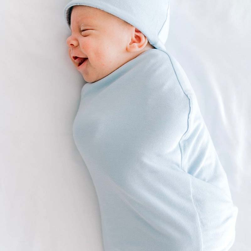 Reversible bon voyage design cocoon baby swaddle in bamboo cotton fabric.