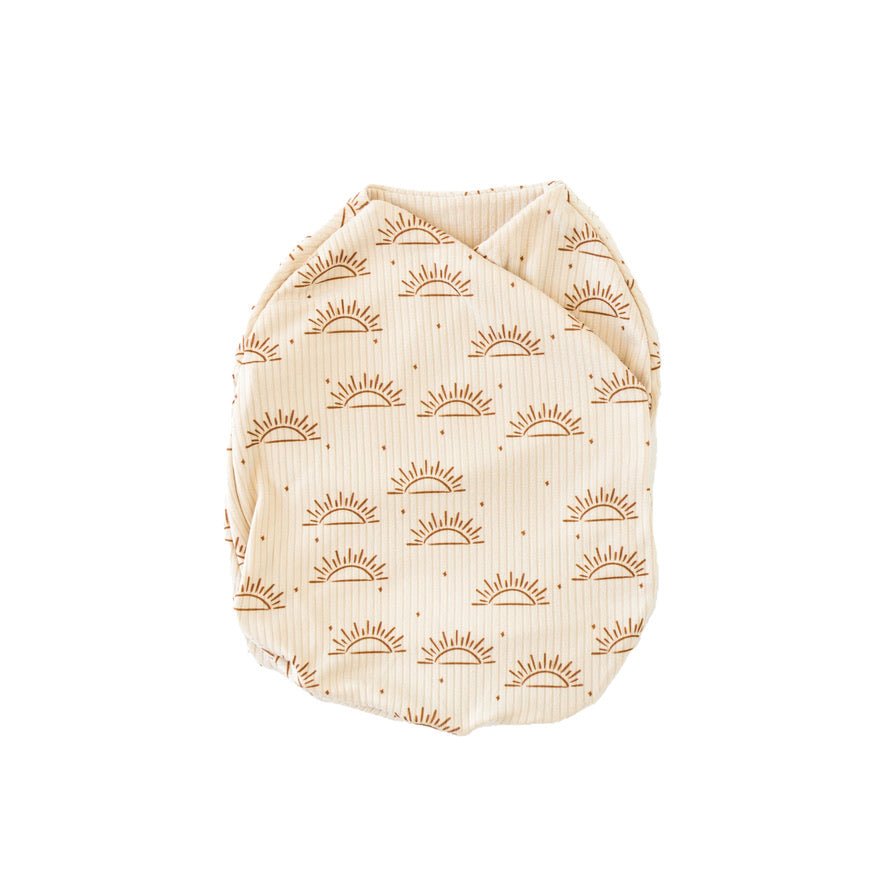Sandy sunsets design cocoon baby swaddle in classic brushed fabric.