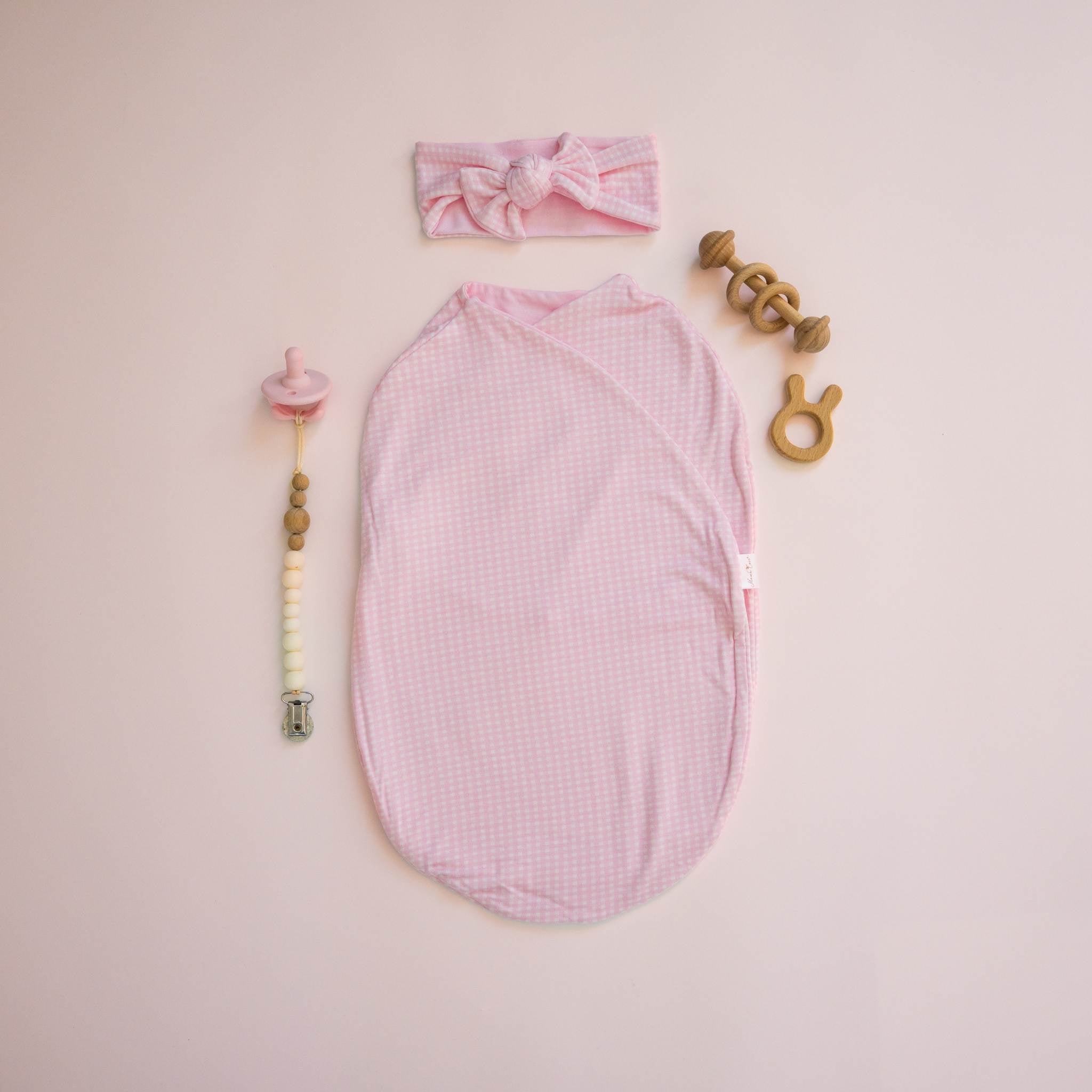 Cocoon swaddle blanket for infants in Silky Modal fabric styles showcasing a classic Baby Pink Gingham pattern.