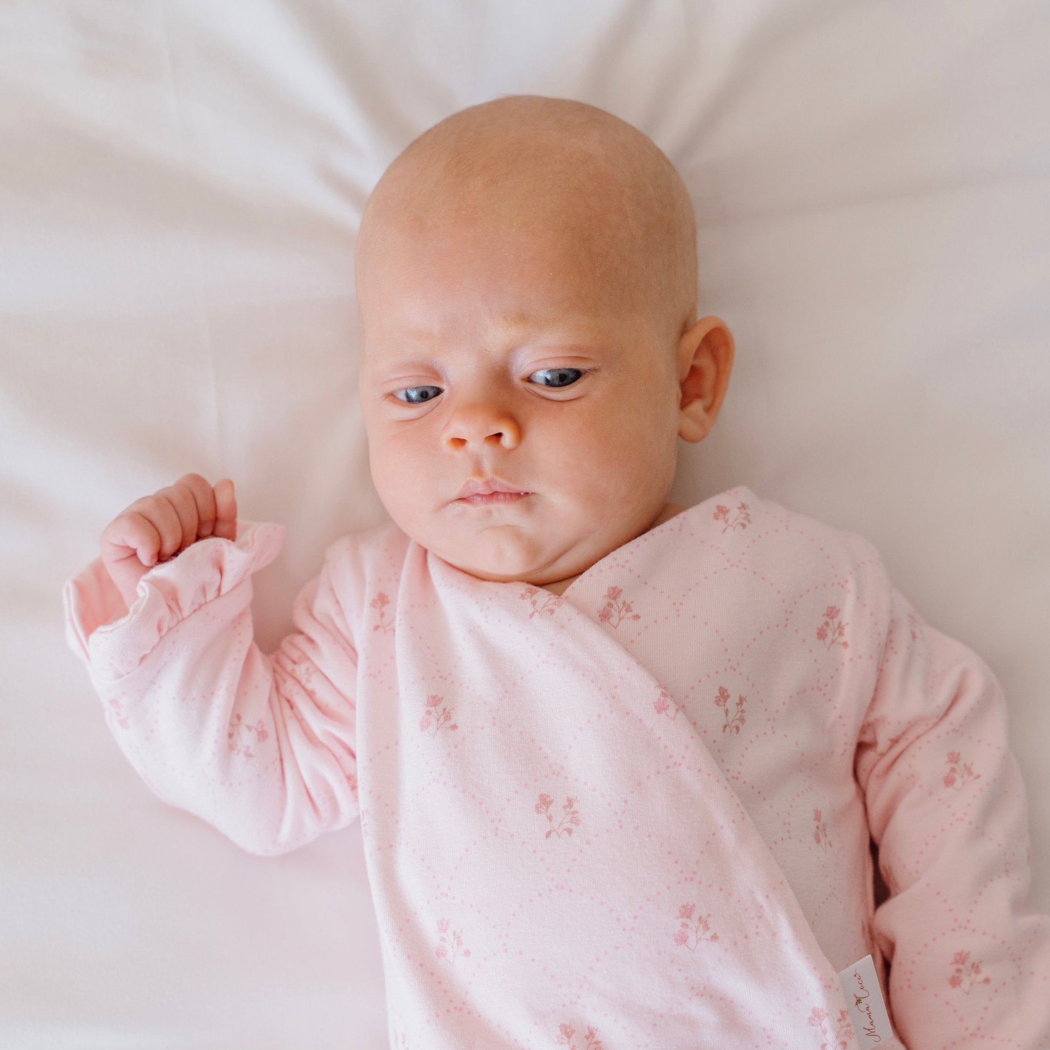 Ruffle cuff long sleeve baby winged bodysuit made from bamboo cotton in dainty dots design.