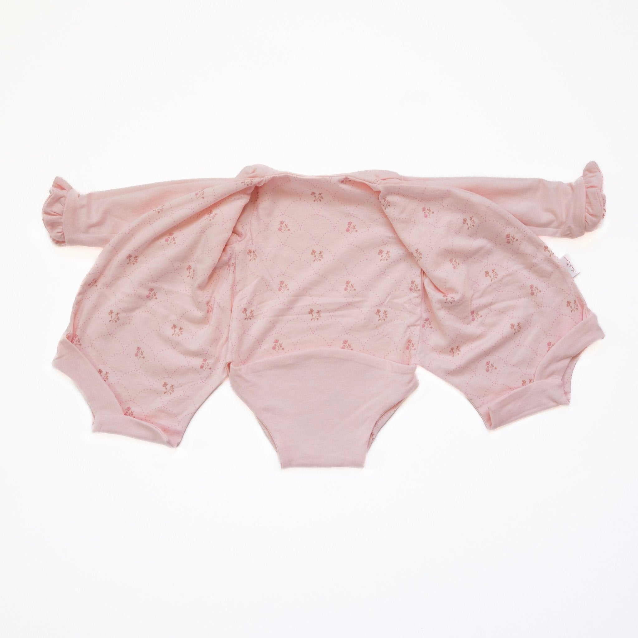 Ruffle cuff long sleeve baby winged bodysuit made from bamboo cotton in dainty dots design.