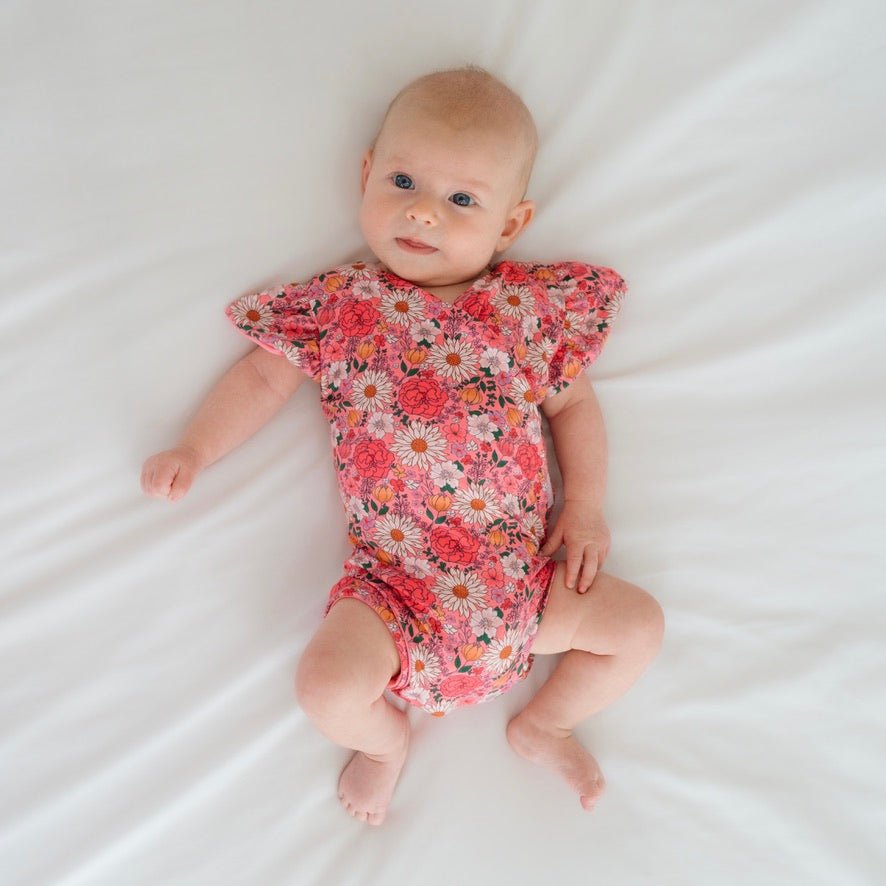 Flower power design flutter sleeve baby onesie in classic brushed fabric.