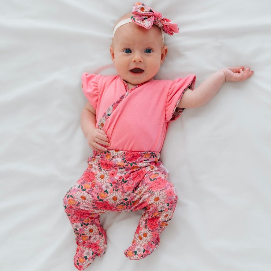 Reversible short-sleeve bodysuit for baby showcasing Flower Power and premium brushed fabric.