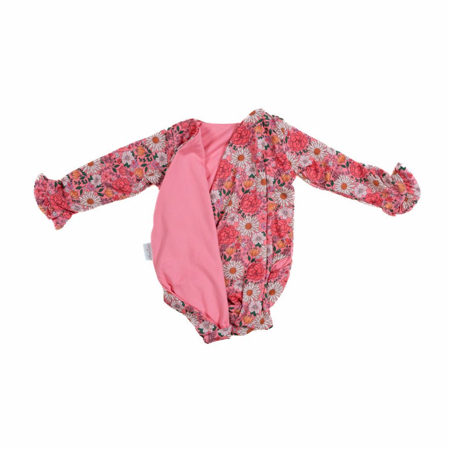 Reversible flower power long sleeve ruffle cuff baby onesie.