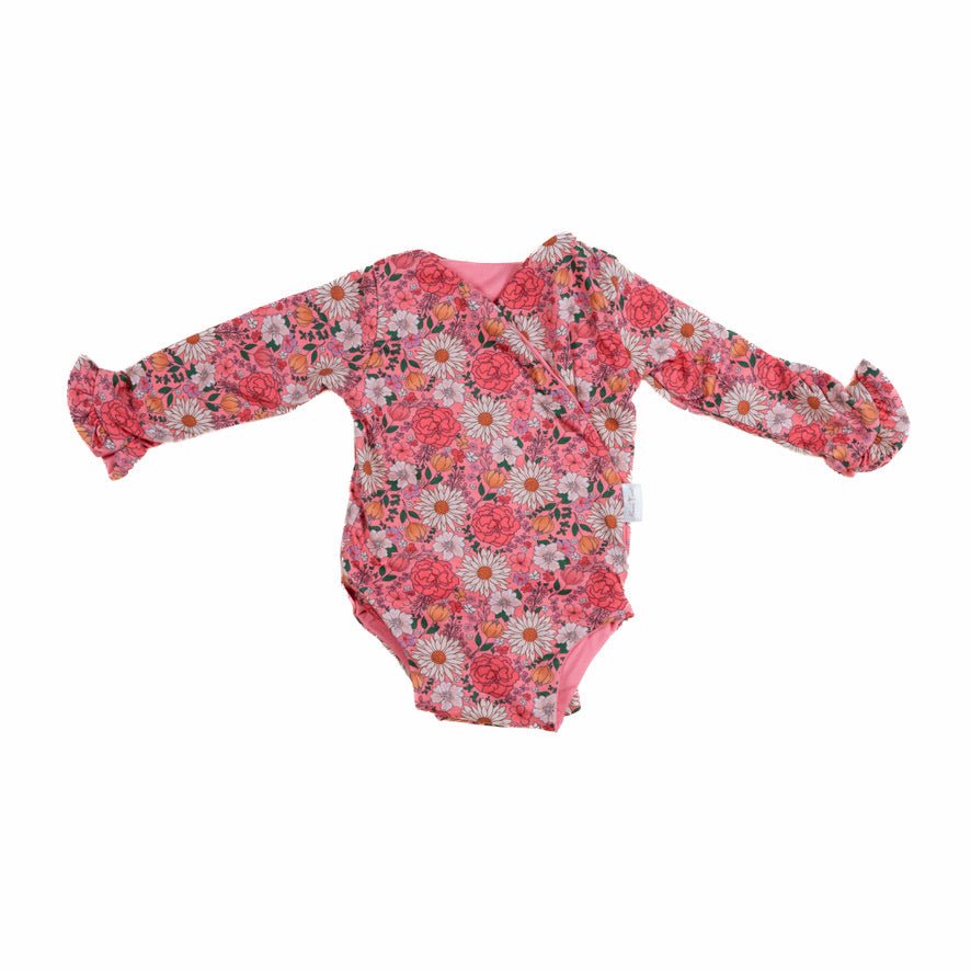 Winged long sleeve infant bodysuit crafted from cozy Flower Power design brushed fabric with ruffle cuffs.