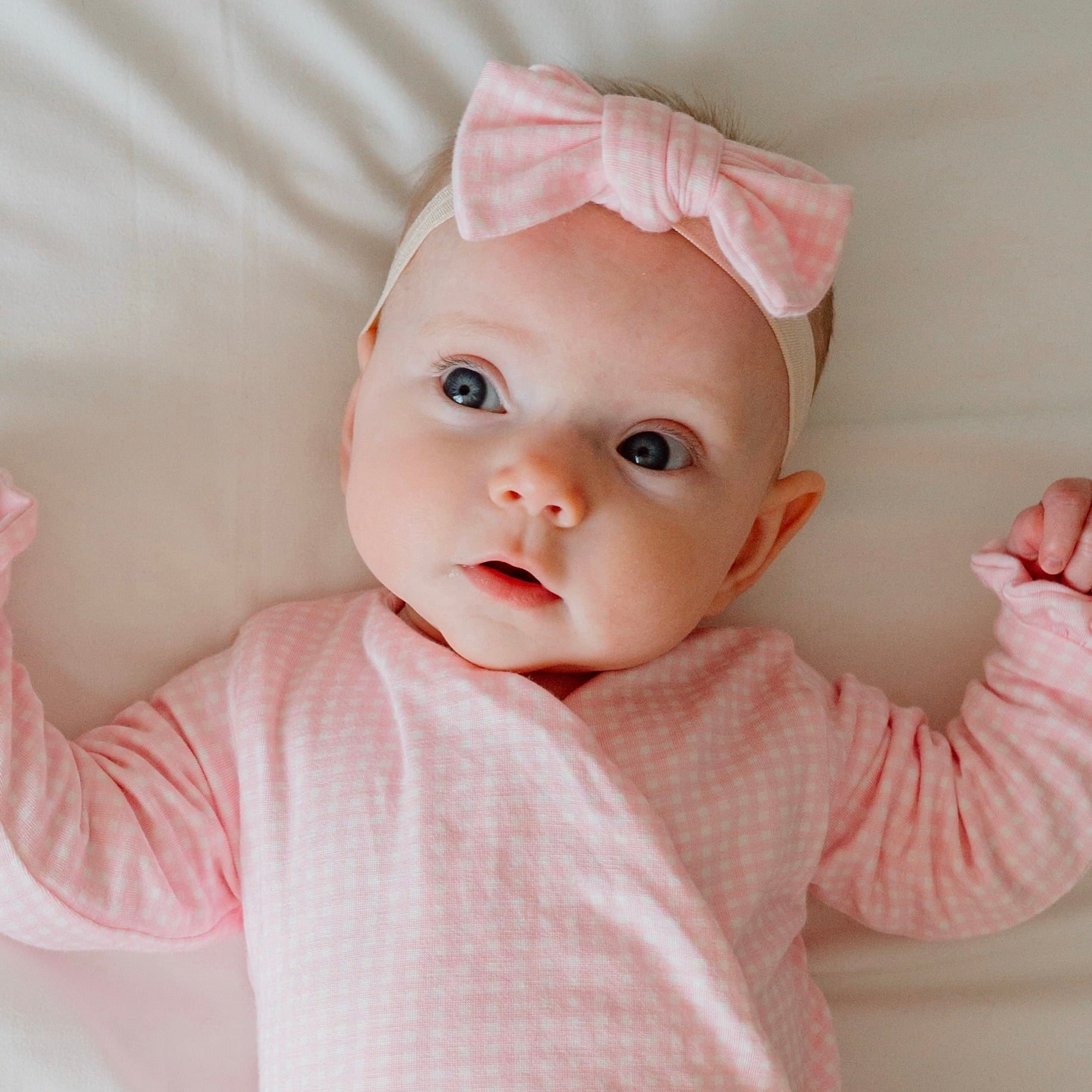 Flutter sleeve baby onesie outfit bundle made from silky modal fabric in baby pink gingham design.