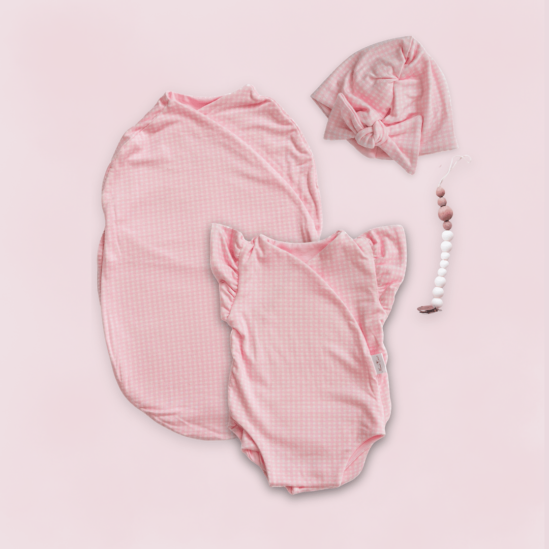 Newborn essentials bundle with flutter sleeves in silky modal fabric with baby pink gingham design.