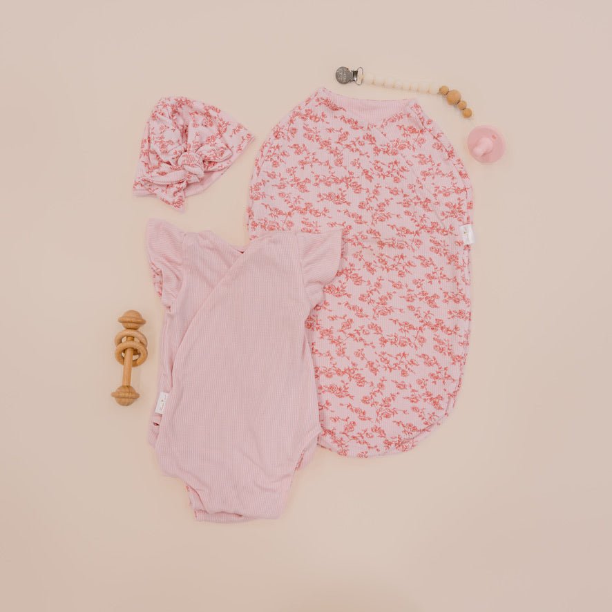 Newborn essentials bundle with flutter sleeves in silky modal fabric with bitty pink blooms design.