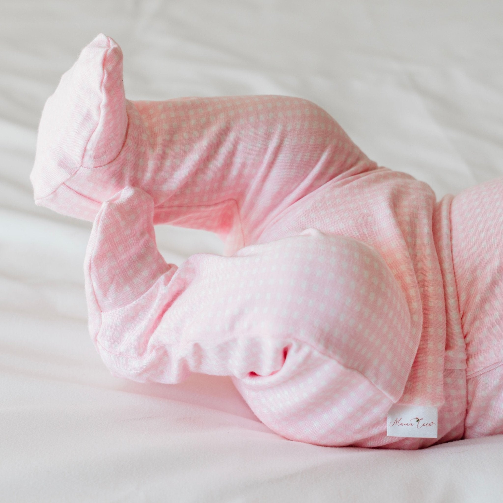 Baby footie pants in baby pink gingham design.