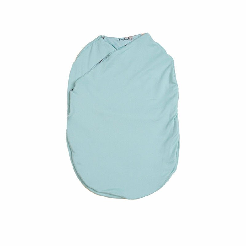 Reversible newborn baby cocoon swaddle featuring World Traveler design Silky Modal fabric.