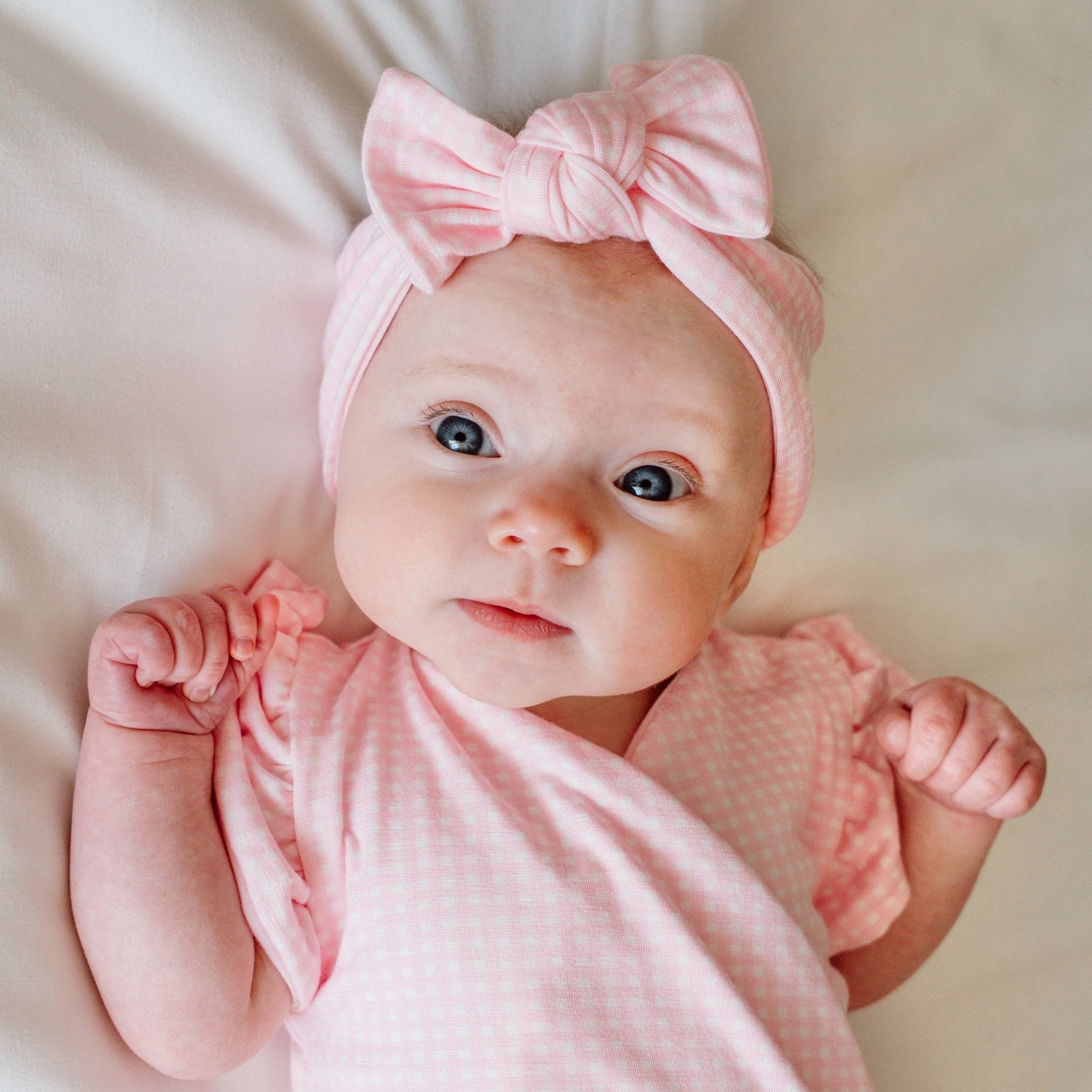 Headwrap with bow in Baby Pink Gingham design, made from silky modal fabric.