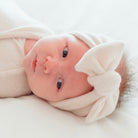 Adorable baby bow headwrap available in luxurious Plush Latte.