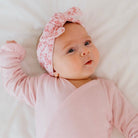 Headwrap with bow in Bitty Pink Blooms design, made from silky modal fabric.
