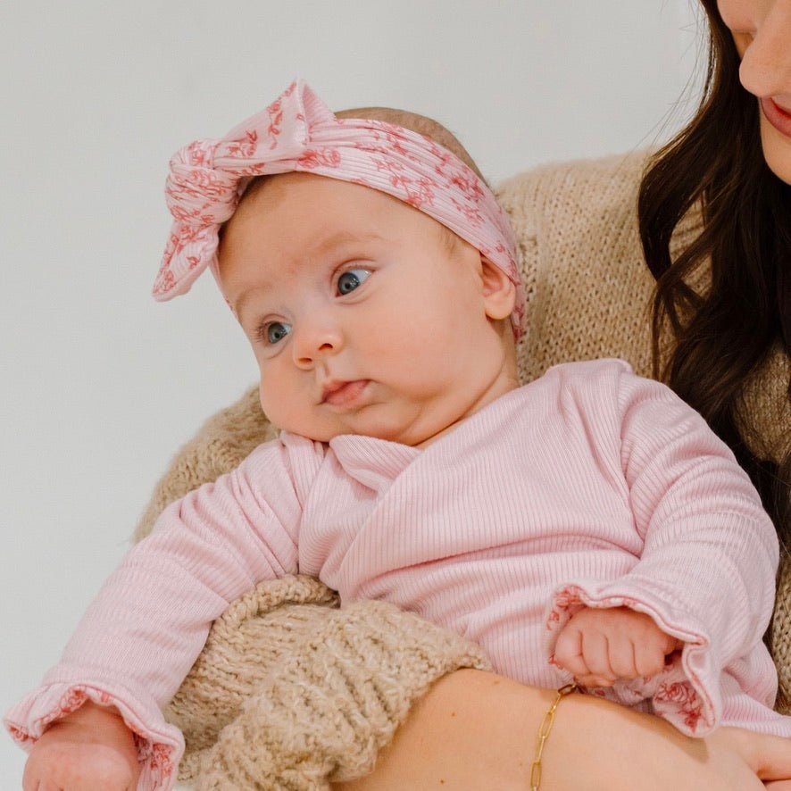 Adorable bow headwrap available in luxurious silky modal with Bitty Pink Blooms design.