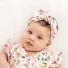 Headwrap with bow in Peachy Rose Fields design, made from classic brushed fabric.