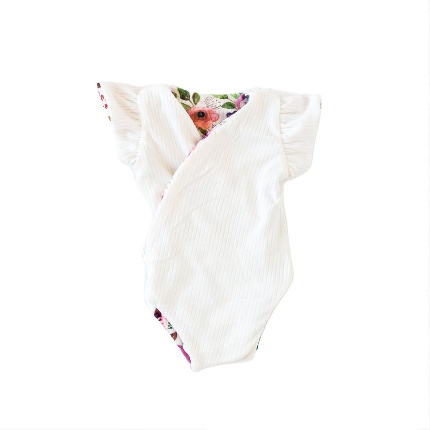 Reversible Ivory Wildflowers short-sleeve baby bodysuit in Classic Brushed fabric styles.