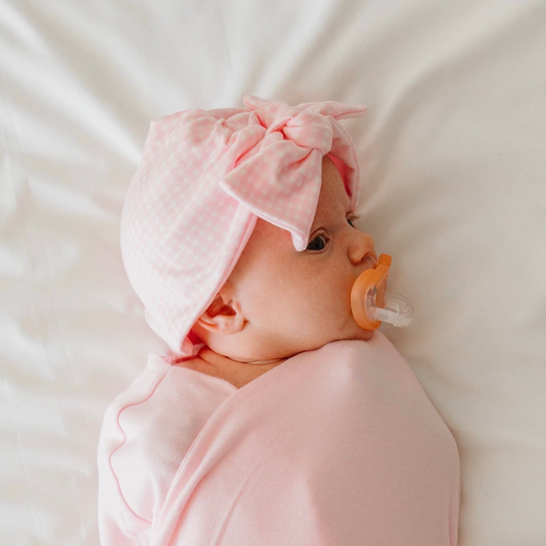 Baby pink gingham ruffle cuff long sleeve baby onesie outfit bundle made from silky modal fabric.