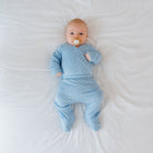 Reversible long-sleeve winged bodysuit and footie pants in dotted blue design.
