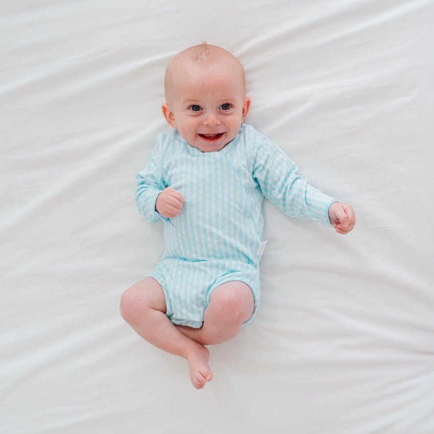 Reversible long-sleeve winged bodysuit in lil surfer design.