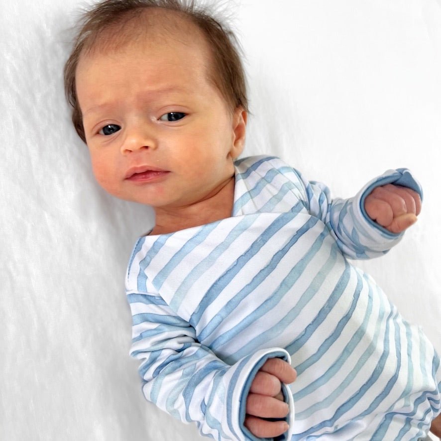 Reversible long-sleeve winged bodysuit in chambray waves design.