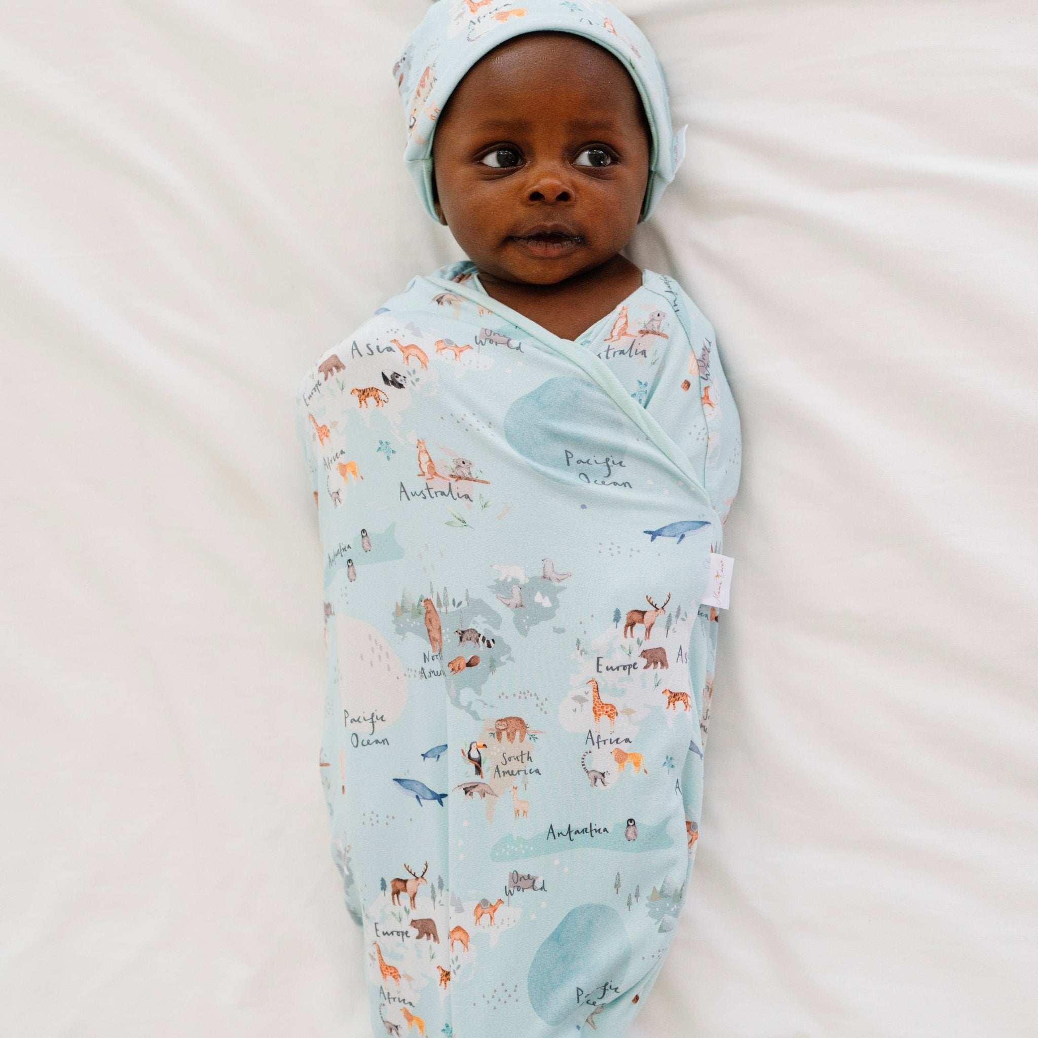 Classic-brushed short sleeve newborn essentials bundle in world traveler design.