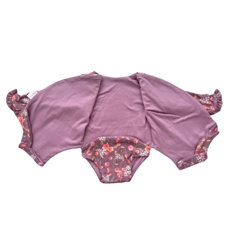 Winged long sleeve infant bodysuit crafted from cozy Peachy Lilac design reversible brushed fabric with ruffle cuf