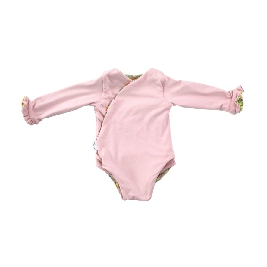 Long sleeve winged baby bodysuit featuring reversible ruffle cuffs in soft Pink Lemonade design brushed fabric.