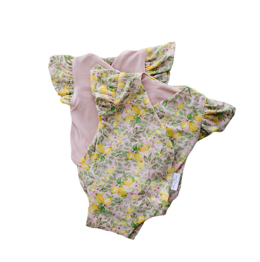 Reversible Pink Lemonade floral baby bodysuit with comfortable short sleeves.