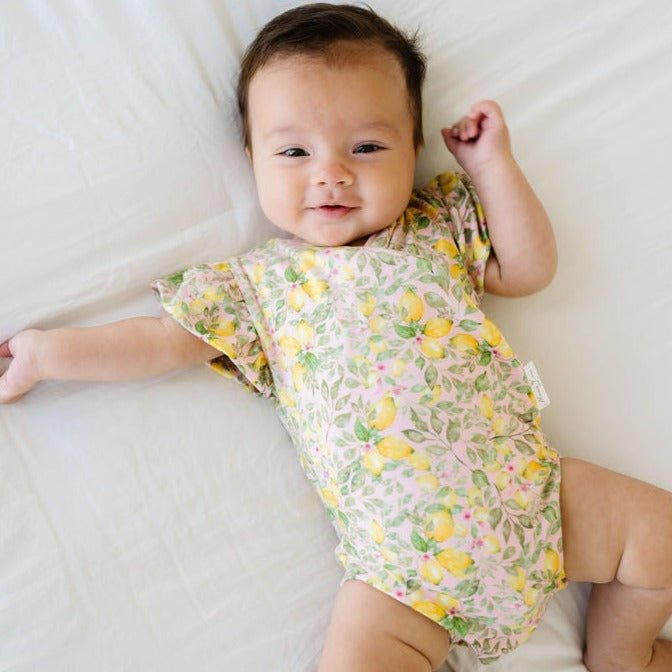 Baby short-sleeve bodysuit featuring Pink Lemonade and Classic Brushed fabric styles.